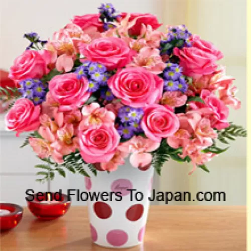 Pink Roses, Pink Orchids And Assorted Purple Flowers Arranged Beautifully In A Glass Vase