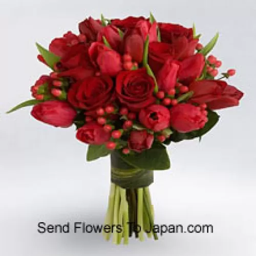Gros bouquet de roses rouges et de tulipes rouges avec des garnitures de saison rouges.
